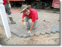 Alex Ostrega placing Pavers